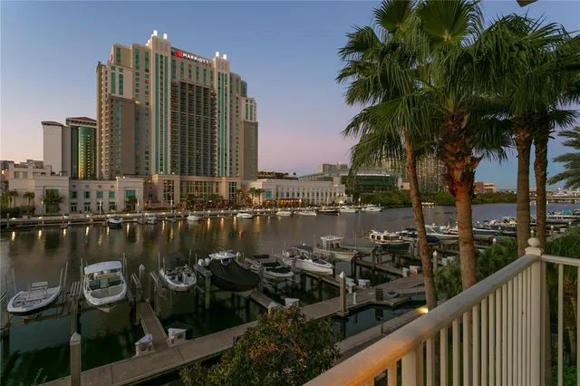 a living room with furniture a fireplace and a chandelier