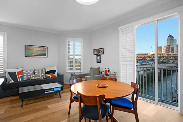 a living room with furniture a window and a dining table
