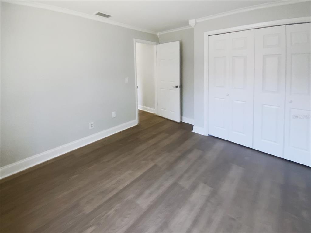 10454 138th Street Largo, FL 33774 - Photo 18 of 35 a view of an empty room with wooden floor
