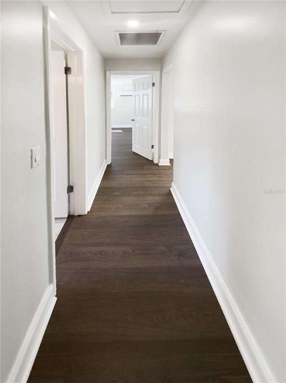 10454 138th Street Largo, FL 33774 - Photo 19 of 35 a view of a hallway with wooden floor