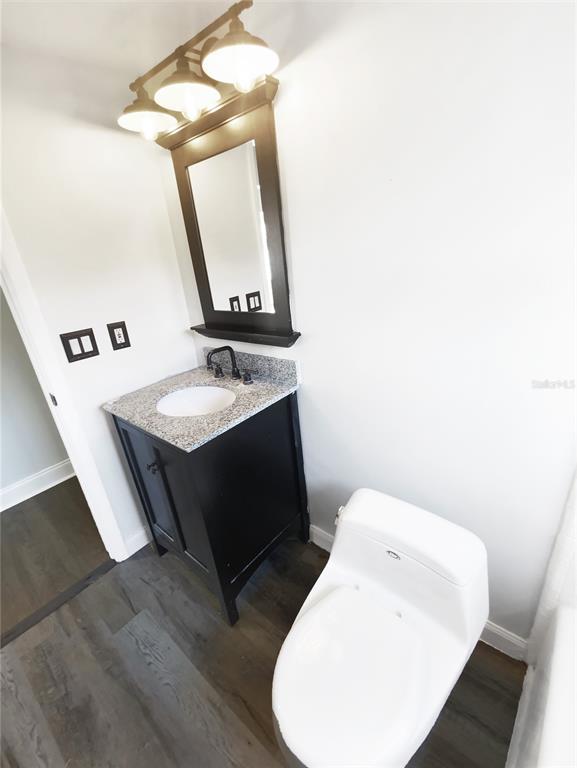 10454 138th Street Largo, FL 33774 - Photo 21 of 35 a bathroom with a granite countertop sink and a mirror