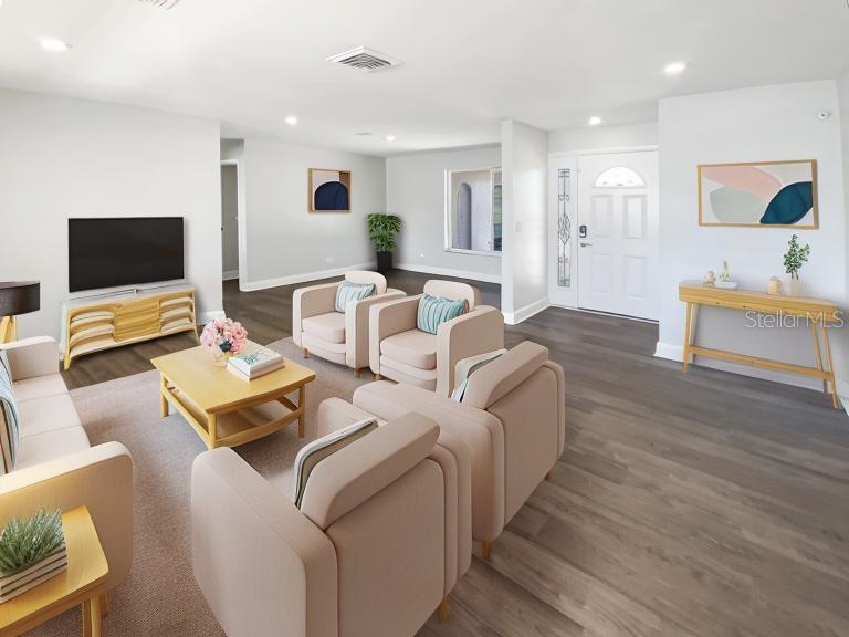 10454 138th Street Largo, FL 33774 - Photo 7 of 35 a living room with furniture and a flat screen tv