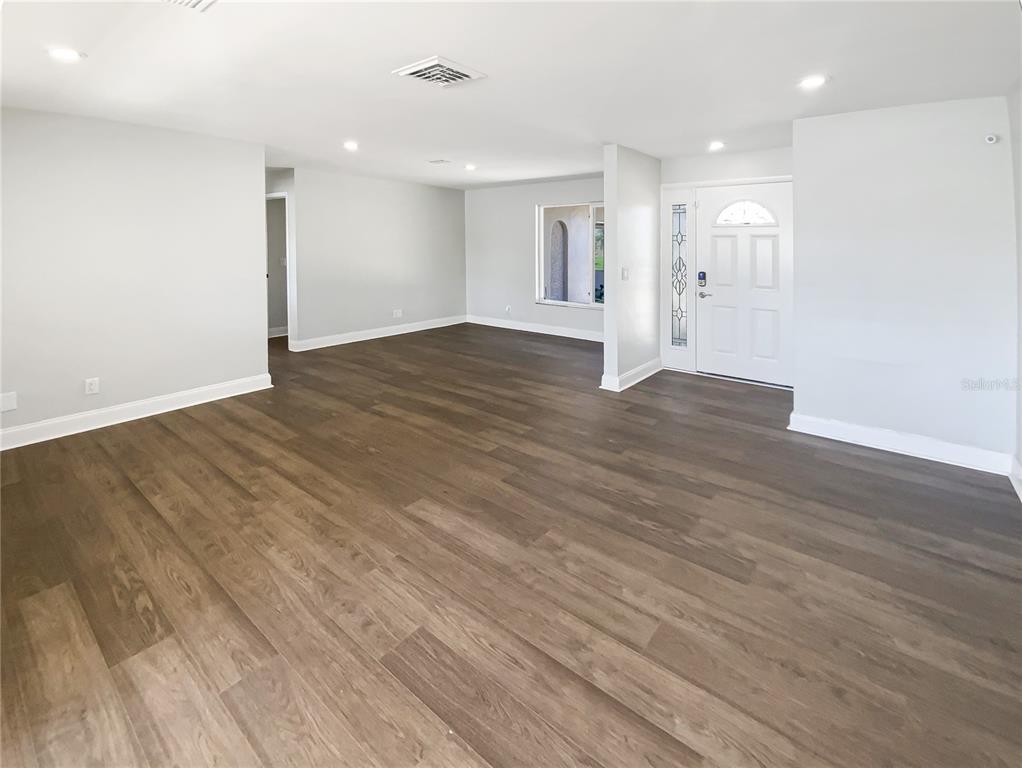 10454 138th Street Largo, FL 33774 - Photo 8 of 35 a view of empty room with wooden floor