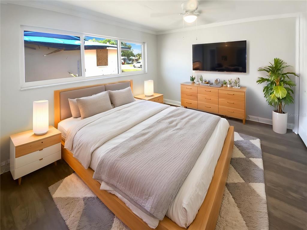 10454 138th Street Largo, FL 33774 - Photo 10 of 35 a bedroom with a bed and a television