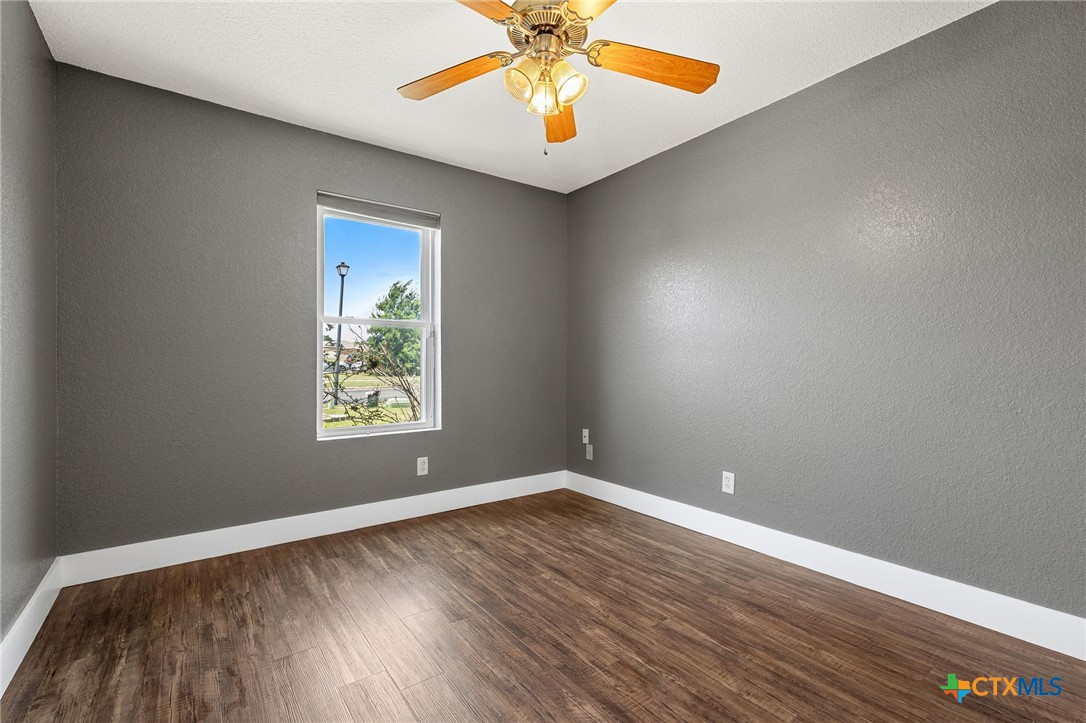 3208 Viewcrest Drive Killeen, TX 76549 - Photo 9 of 15 wooden floor in an empty room with a window