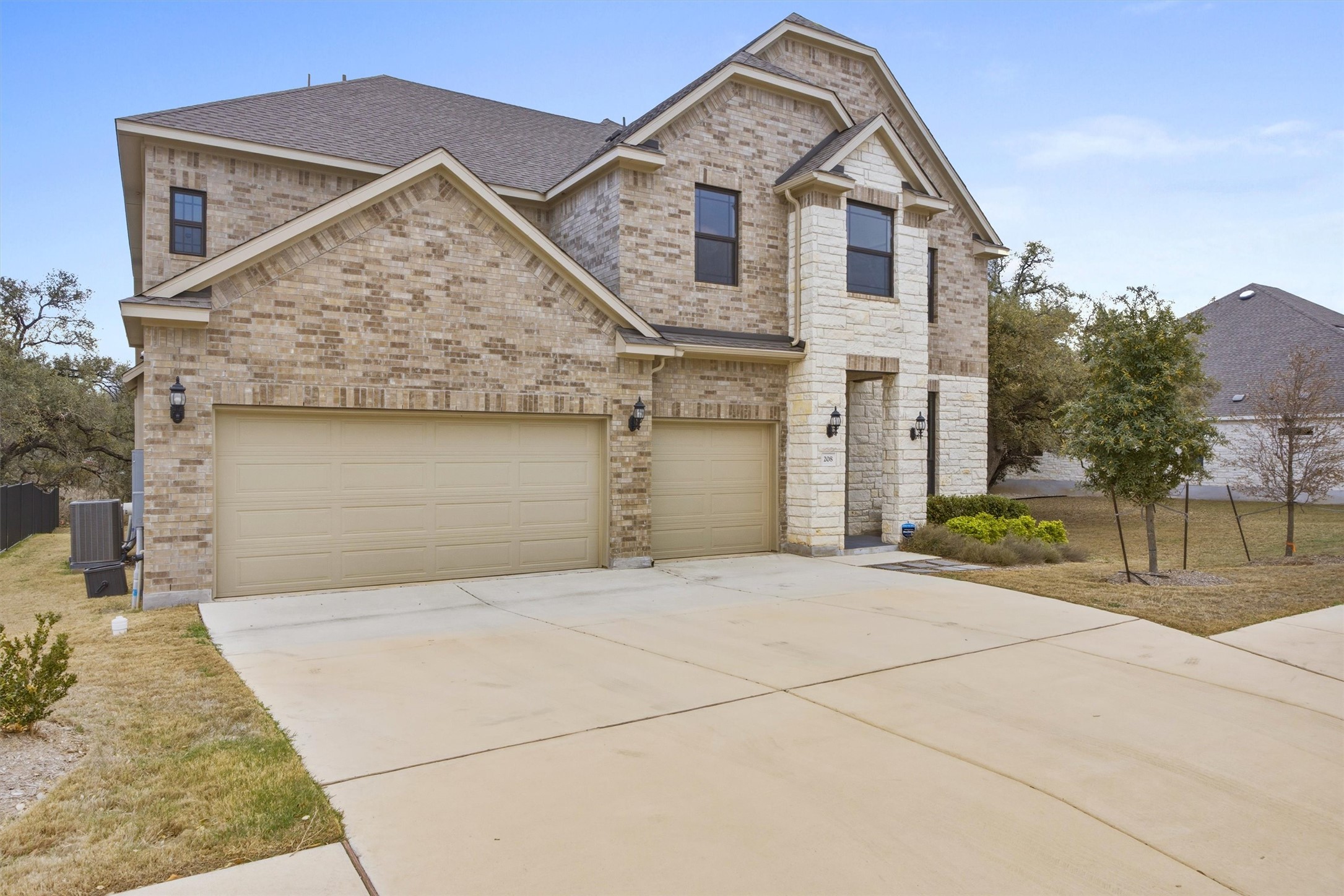 208 Tovas Secret Cove Georgetown, TX 78628 - Photo 2 of 40 a front view of a house with a yard and garage