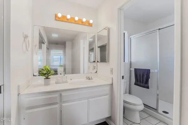 a bathroom with a shower and a window