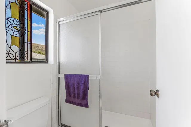 a bedroom with a bed and a table