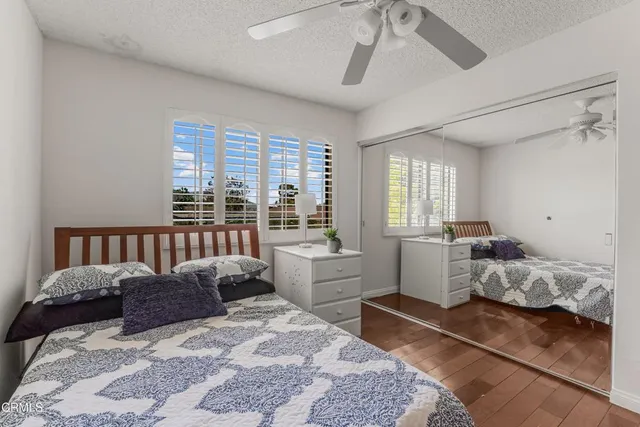 a bedroom with furniture and a wooden floor