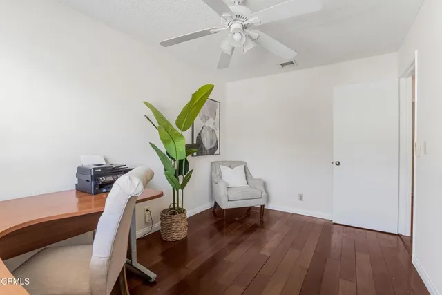 a workspace with furniture and a potted plant