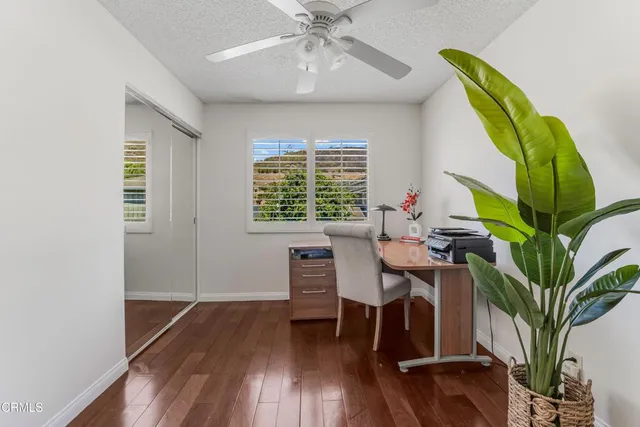 a bathroom with a granite countertop sink a toilet and a mirror