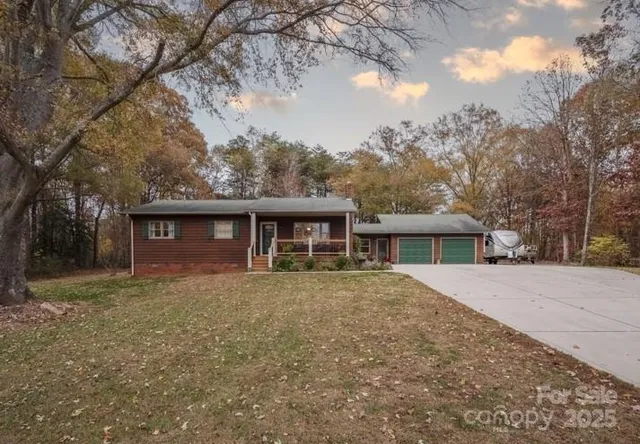 a front view of house with yard and trees