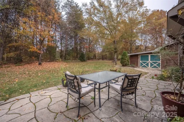 a backyard of a house with table and chairs