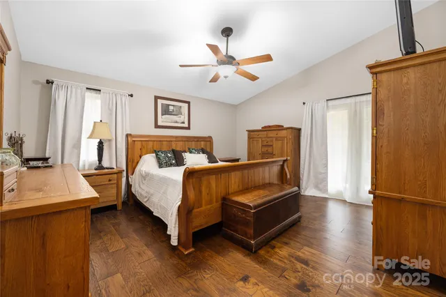 a bedroom with a bed dresser and a window