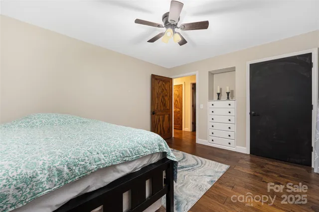 a living room with hard wood floors and a ceiling fan
