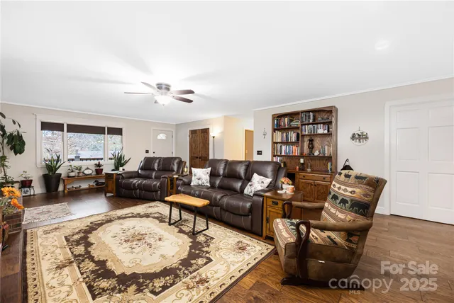 a living room with furniture a rug and a large window
