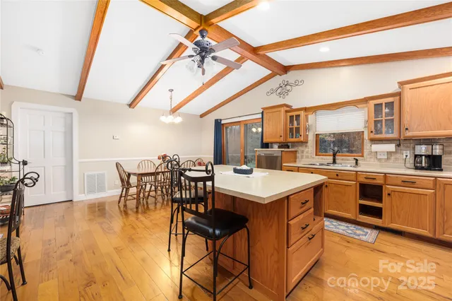 a kitchen with a table chairs stove and cabinets