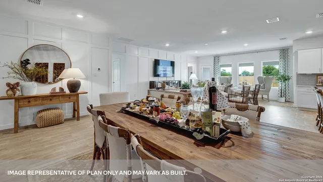a living room with kitchen furniture and a wooden floor