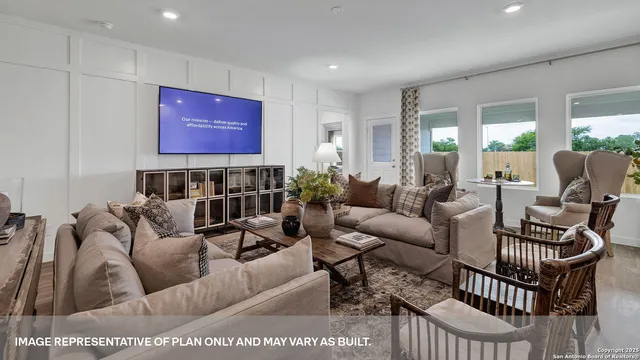 a living room with furniture a rug and a flat screen tv