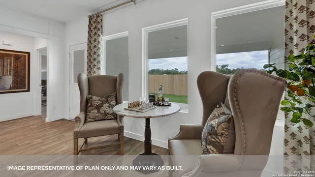 a kitchen with stainless steel appliances a sink a stove a refrigerator cabinets and a dining table