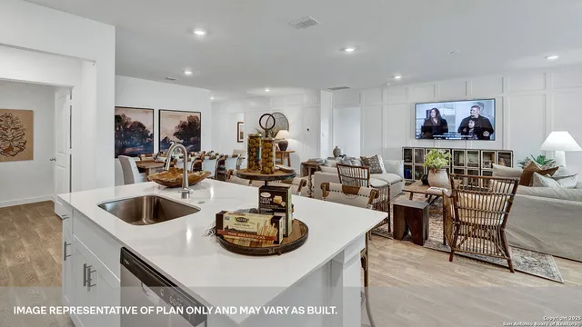 a living room with furniture a floor to ceiling window and potted plant