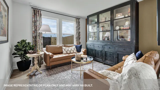 a bedroom with a bed a couch and large windows