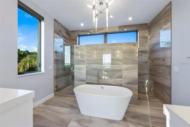 a bathroom with a tub sink and mirror
