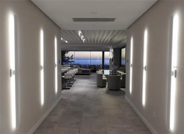 a living room with fireplace furniture and a large window