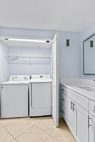 a view of a kitchen with a sink and a refrigerator