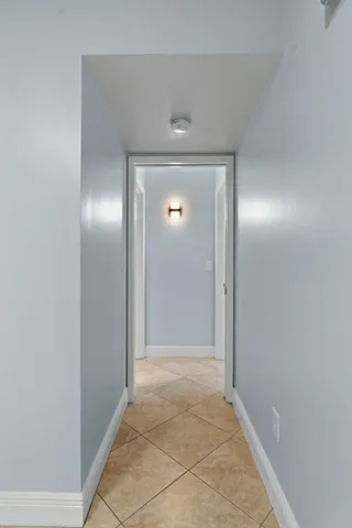 an empty room with window and ceiling fan