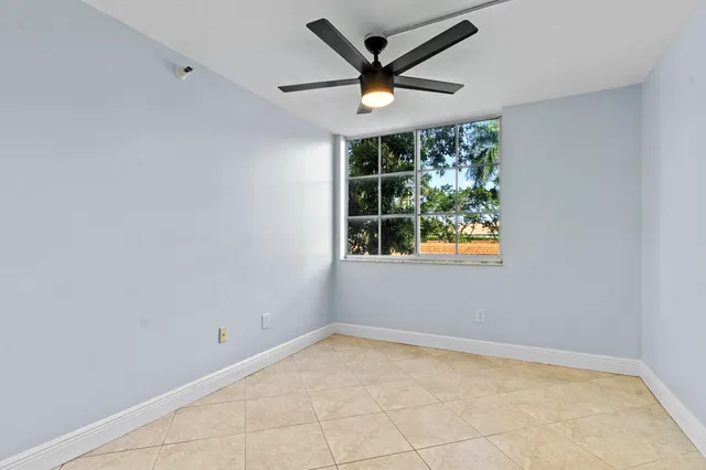 a view of a livingroom with a ceiling fan and window