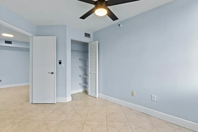 a view of a big room with wooden floor and a ceiling fan