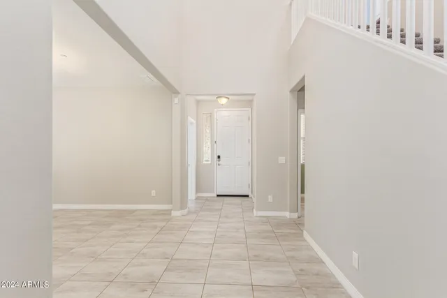 a view of staircase with railing and white walls
