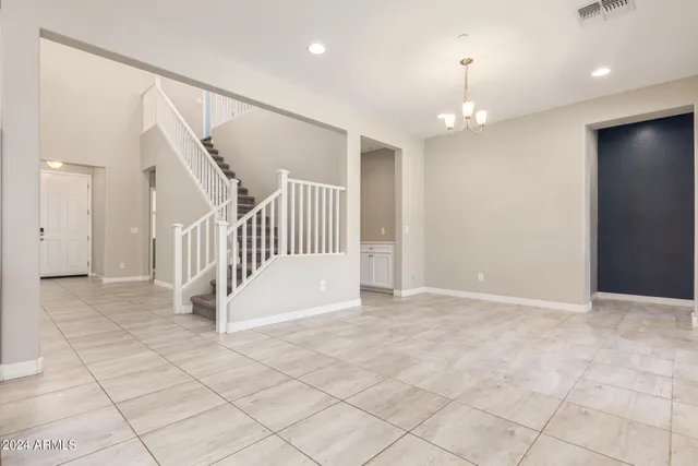 a view of an empty room with a fireplace and a window