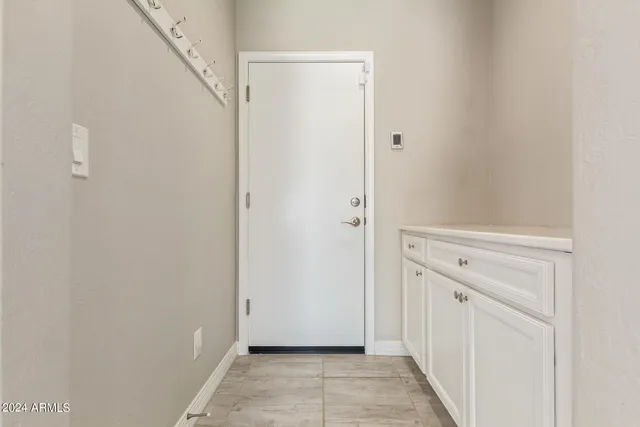 a kitchen with stainless steel appliances granite countertop a sink a stove a refrigerator and island with wooden floor