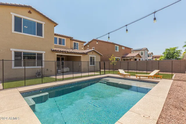a view of a house with swimming pool and sitting area