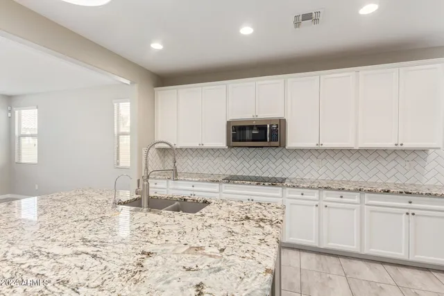 a bathroom with a sink vanity and mirror