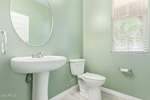 a bathroom with a shower a toilet and a sink