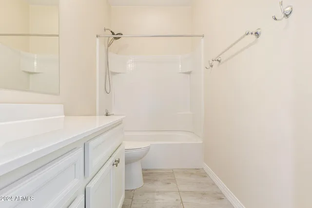 a view of a backyard with a garden and an umbrella