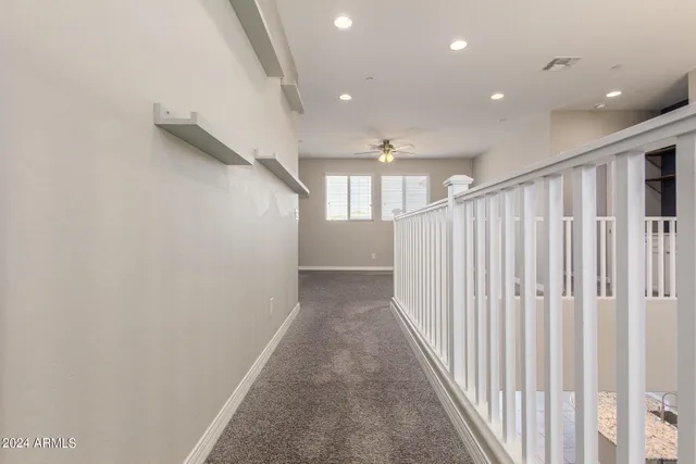 a view of a park with a fountain plants and large tree
