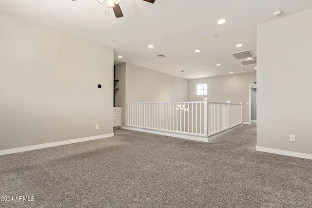 a view of a patio with a table chairs potted plants and a large tree