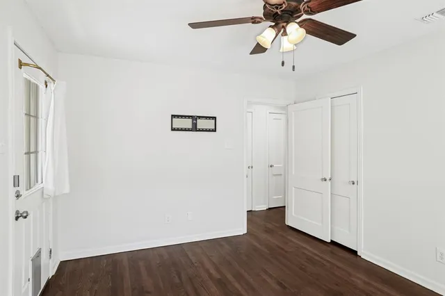 a view of an empty room and wooden floor