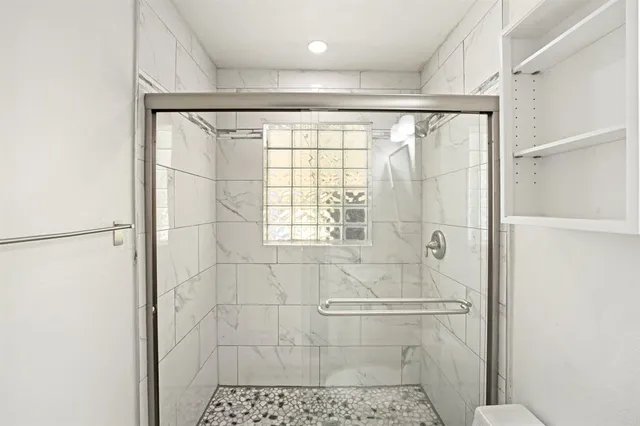a bathroom with a shower and a sink