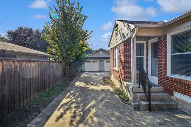 a view of house with backyard and sitting area