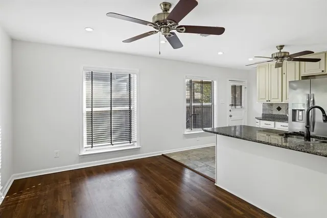 a view of a kitchen with a sink and wooden floor