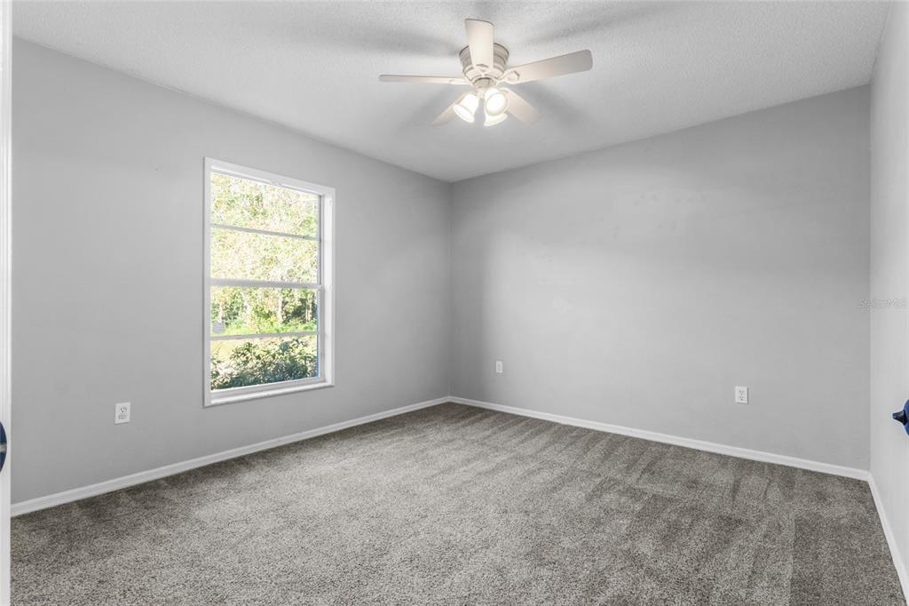 4644 Sawgrass Boulevard New Port Richey, FL 34653 - Photo 11 of 34 an empty room with a window and a fan