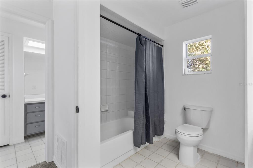 4644 Sawgrass Boulevard New Port Richey, FL 34653 - Photo 16 of 34 a bathroom with a toilet a sink and shower