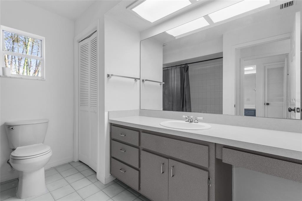 4644 Sawgrass Boulevard New Port Richey, FL 34653 - Photo 17 of 34 a bathroom with a toilet sink and mirror