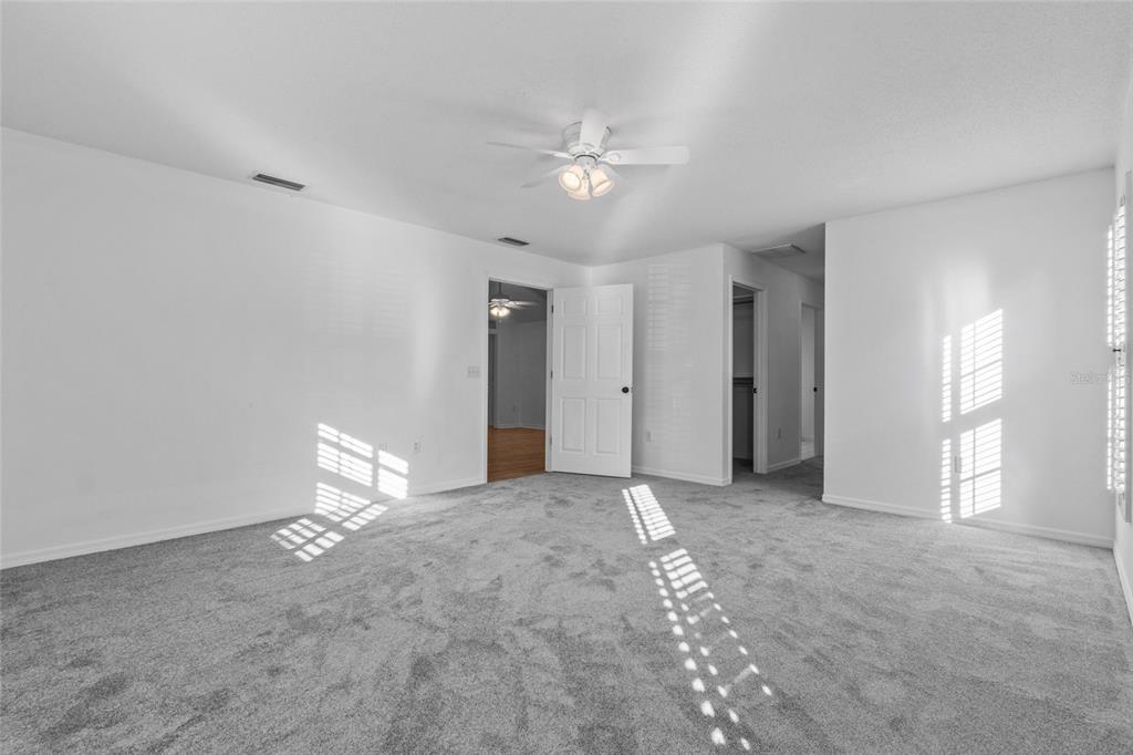 4644 Sawgrass Boulevard New Port Richey, FL 34653 - Photo 19 of 34 a view of an empty room with a ceiling fan