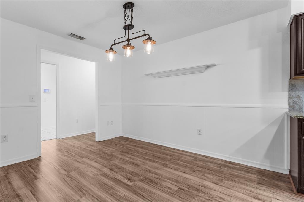 4644 Sawgrass Boulevard New Port Richey, FL 34653 - Photo 9 of 34 a view of a room with wooden floor